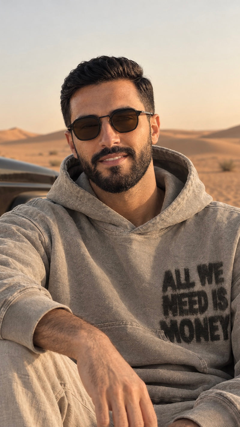 A man driving in a kandura, wearing the Oculus Classic in amber
