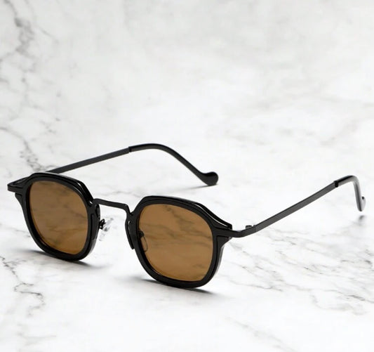 Oculus Classic sunglasses with amber polarized lenses resting on white marble
