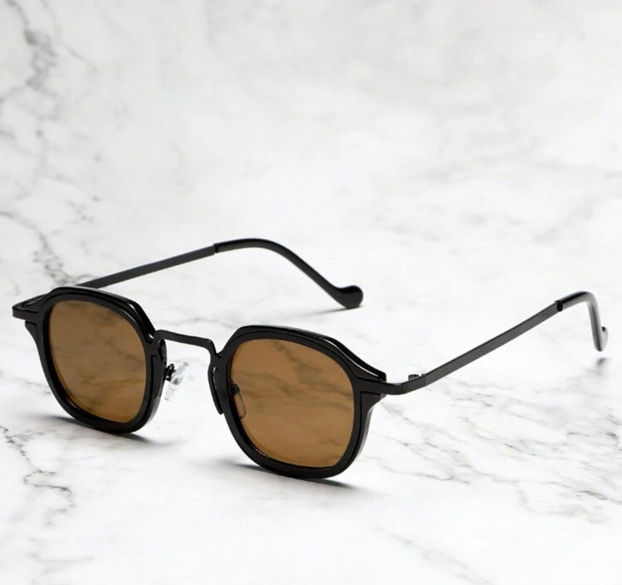Oculus Classic sunglasses with amber polarized lenses on white marble