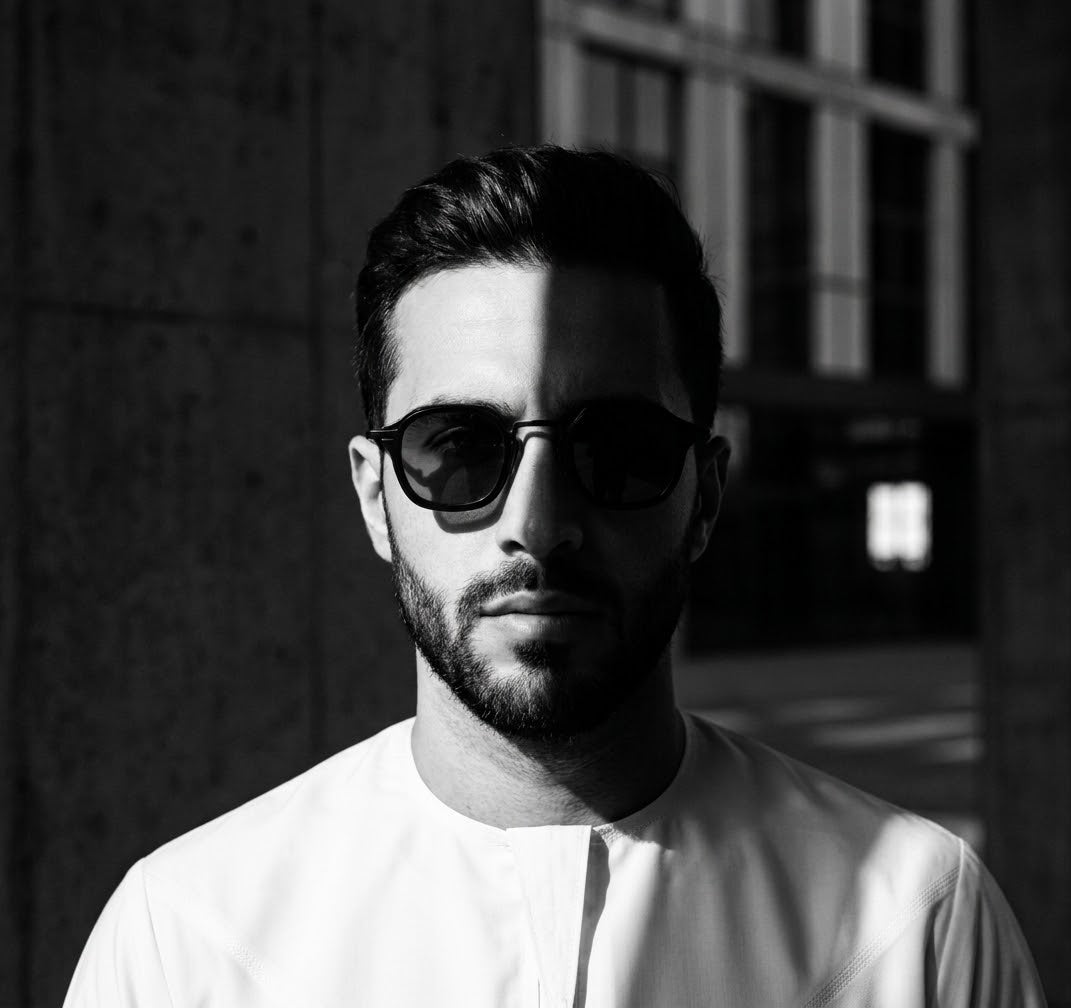 Black and white portrait of a man wearing Oculus sunglasses